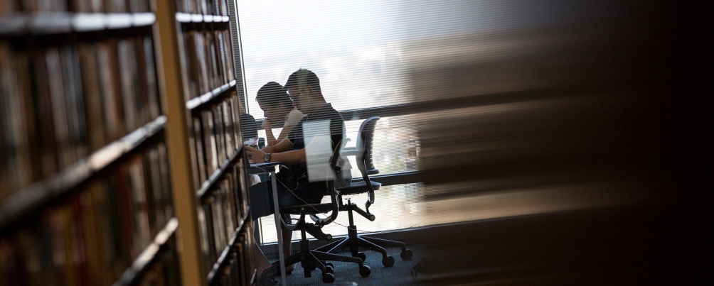 Two students read quietly in a study room at the Loyola Marymount University library.